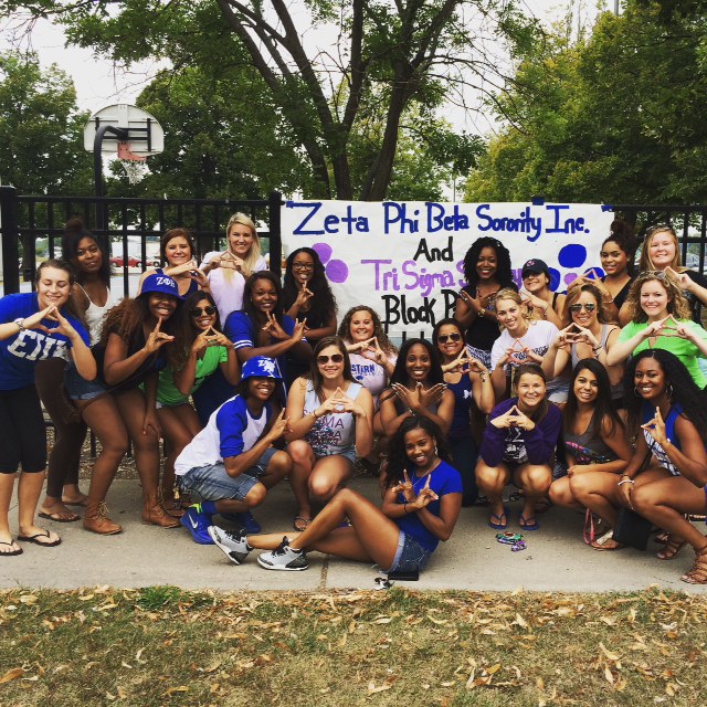 Zeta Phi Beta Sorority Inc. and Tri Sigma Sorority pose together holding up their signiture Greek hand signs at a past block party. Zeta Phi Beta will host another block party August 26, 2016 in Taylor Courts.