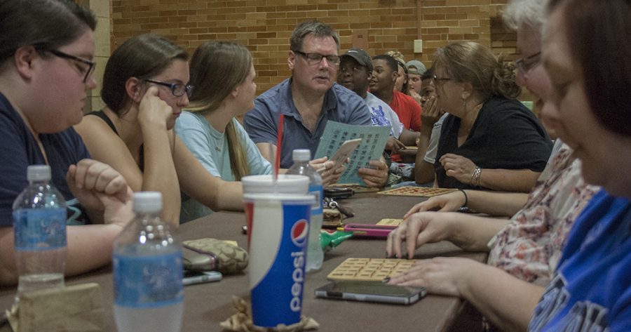 Merritt Harrison, a resident of Naperville, IL, reads his BINGO card aloud as his family and friends watch and listen to see if he had a winning card during “Family BINGO Bonanza” Friday in McAfee Gym.