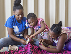 Ariel Taylor, a sophomore family and consumer sciences major, makes a fleece blanket with her niece Janyiah Clark, 6 and cousing Amariana Beal, 7. Taylor said her Family Weekend was going well so far, and that her family members had not driven her crazy-yet.