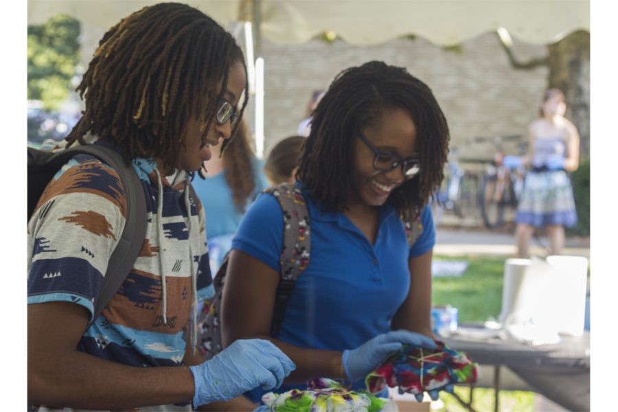 Breanna Young, a junior applied engineering and technology major, tie dyes a shirt and talks to her peer Arius ONeal, a junior family and consumer sciences major, during the Tie Dyeversity event Tuesday between Klehm Hall and the Life Science building.