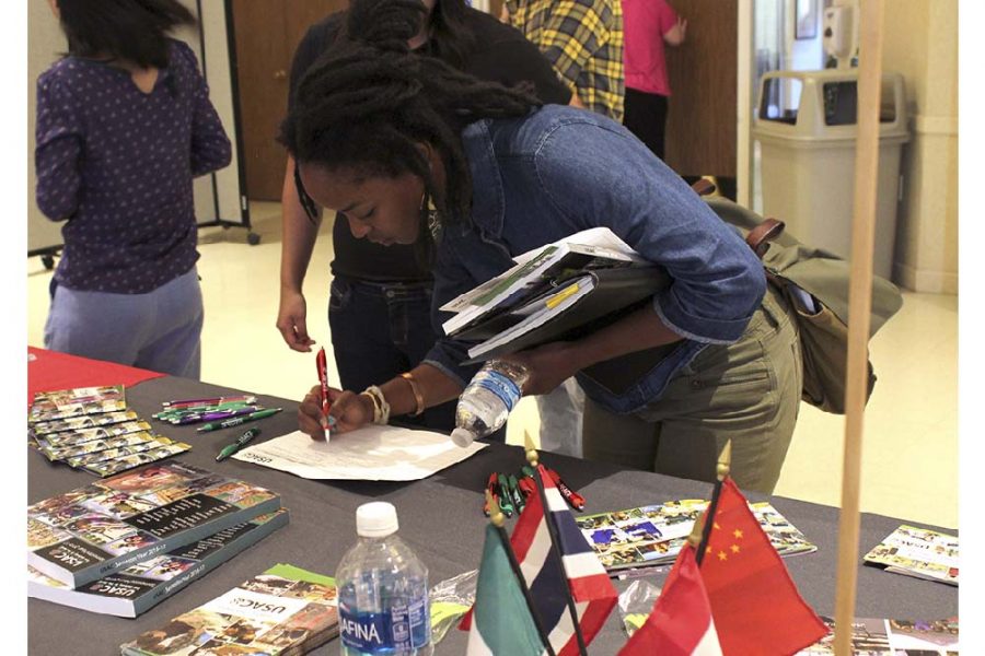 Alleluia Musabyimana, a junior sociology major, signs up for emails from University Studies Abroad Consortium during the Study Abroad Fair Tuesday in the University Ballroom.