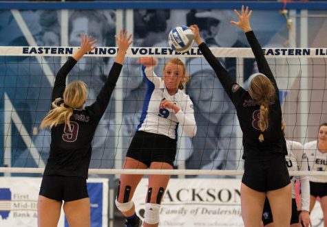 Junior middle hitter Allie Hueston kills the ball past two Eastern Kentucky opponents during the Panthers' 3-2 loss Oct. 14 in Lantz Arena.