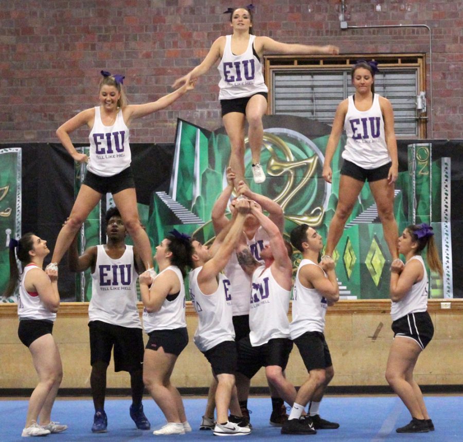 Members of Sigma Kappa sorority and Delta Tau Delta fraternity perform their cheer for the crowd at the OZ-SOME Yell Like Hell pep rally in McAfee gym Friday night.