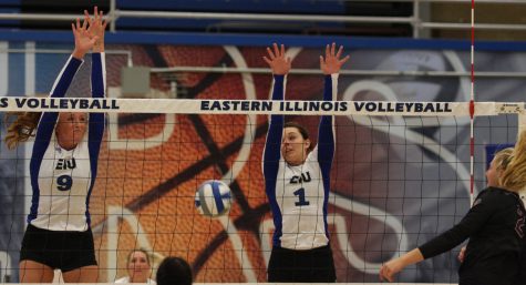 Middle hitters Allie Hueston (9) and Josei Winner (1) attempt a block from a Eastern Kentucky hitter Friday, Oct. 14 at Lantz Arena.