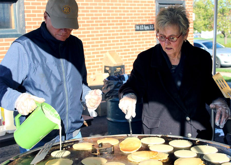 William Warmoth, secretary of the Charleston Rotary Club, pours the pancake batter onto the griddle while Mary Droste, club service director, flips pancakes during the Rotary Pancake Breakfast Saturday morning in the Dirty’s Bar and Grill parking lot.