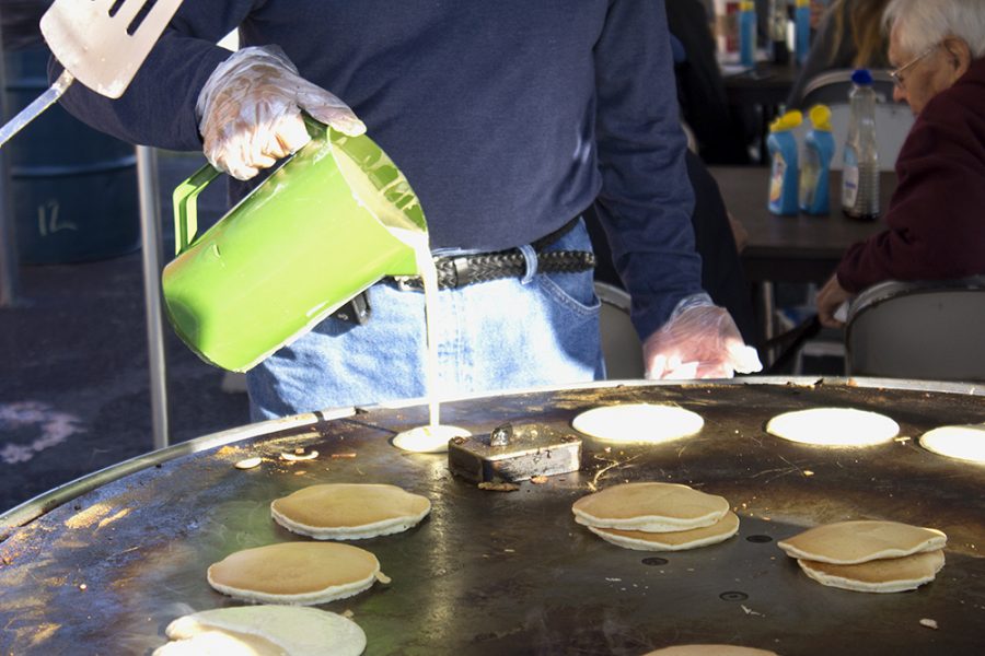 William Warmoth, secretary of the Charleston Rotary Club, pours pancake batter onto the griddle during the Rotary Pancake Breakfast Saturday morning in Dirty’s Bar and Grill parking lot.