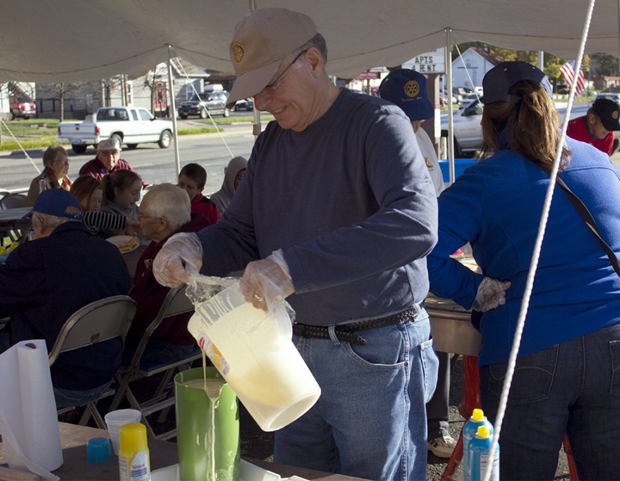 William Warmoth, secretary of the Charleston Rotary Club, pours pancake batter into a pitcher on Saturday morning during the Rotary Pancake Breakfast in Dirty’s Bar and Grill parking lot.