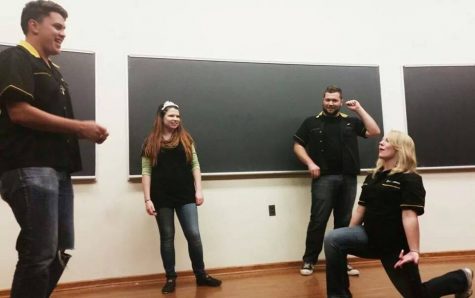 Previous members of the organization Hello Dali acting out a scene. The group does improv comedy in front of a crowd of about 35 people every two weeks.