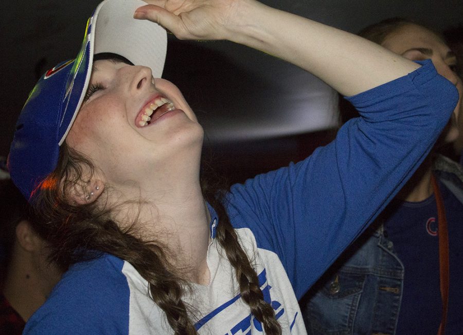 Makayla Digan, a junior special education major, holds her hat and and laughs after the Cubs break the six to six tie in the extra inning Wednesday at the Penalty Box.