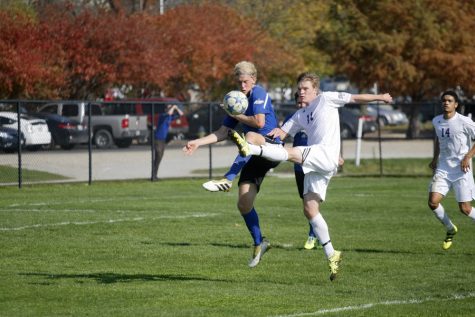 Freshman Anton Olsson fights for the ball to keep it out of the Panther zone Saturday.