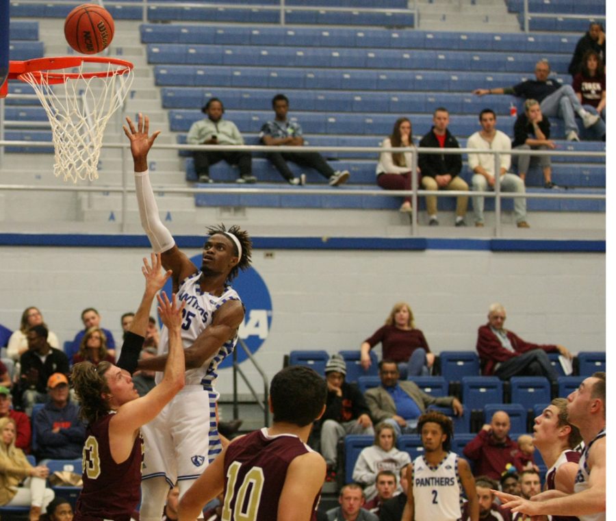 Junior Muusa Dama lays in a basket Sunday against Eureka College at Lantz Arena. Dama scored 14 points and recorded 3 blocks in the 94-58 exhibition game win.