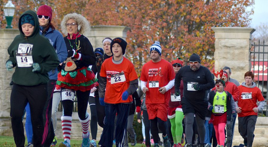 Runners+of+all+ages+participated+in+Saturday%E2%80%99s+fifth+annual+Holiday+Hustle+which+began+and+ended+at+the+gates+outside+of+Old+Main.