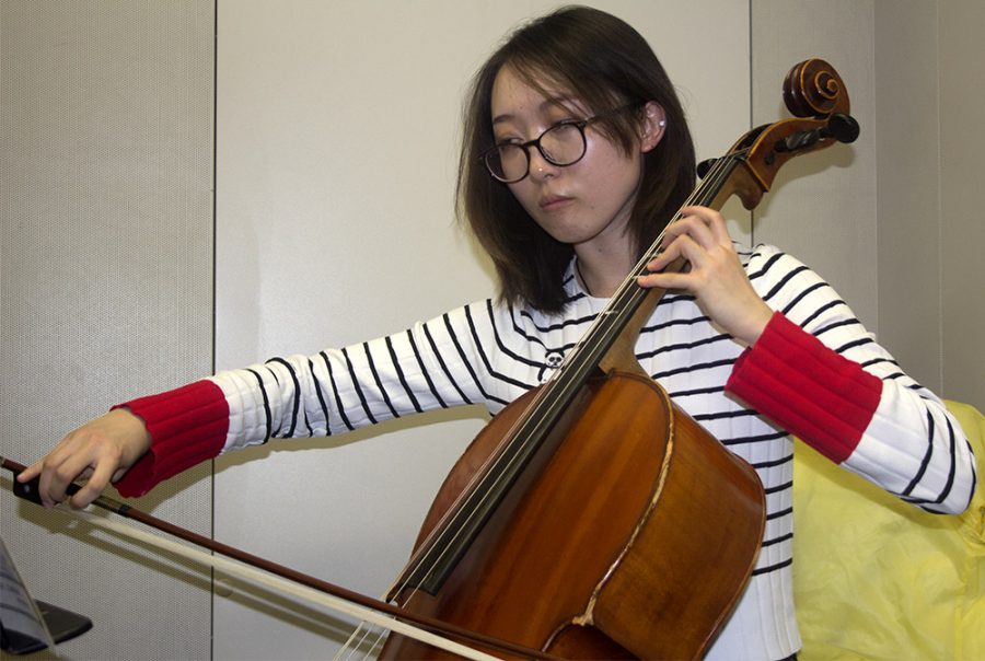 Qruyam Zhou, a freshman music major plays Sonata in A Minor on the cello while practicing for the graduate program in a practice room in the doudna.