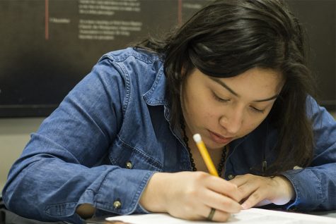 Freshman education major, Alyssa Vergara works on her math 1160 homework in the bridge lounge of the Martin Luther King Jr. Union Monday. Vergara continued to work on her homework after a tutoring session from a math professor. She listed the campus being close to home, a small and the professor to student ratio as the reasons she chose Eastern.