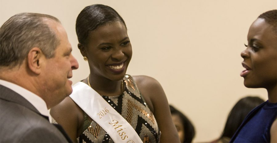 Julianne Adegoriolu, 2016 Miss Black EIU, center, chats with President Glassman and contestant Milove Streeter during a meet and greet for the 2017 Miss Black EIU contestants in the Martin Luther King Jr. Union. Adegoriolu, the “pageant mom,” is in charge of prepping and shaping the new contestants to ensure they are prepared for the pageant along with being great leaders on campus.