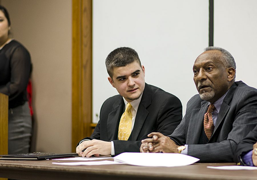 Jack Cruikshank, center, a graduate student studying political science listens to Teshome Abebe answer a question during the Professional Perspectives panel discussion Wedensday in Lumpkin Auditorium.