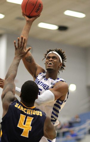 Junior forward Muusa Dama tosses in a basket over Murray State’s Brion Sanchious in a 83-72 OVC loss Thursday, Jan. 12 at Lantz Arena.