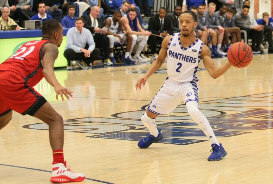 Junior guard Terrell Lewis passes to an open teammate Saturday, Jan. 28 at Lantz Arena. The Panthers defeated the visiting Cougars 75-60.