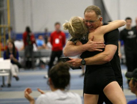 Head coach Tom Akers congratulates junior jumper Haliegh Knapp after she set the conference record in the Women’s High Jump.