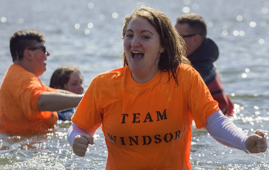 Haylee+Reynolds%2C+a+freshman+at+Windsor+High+School%2C+reacts+to+the+cool+air+as+she+jogs+out+of+the+water+during+the+Polar+Plunge+Saturday+at+Lake+Sarah+in+Effingham.+Reynolds+said+she+participated+because+her+gradmother+is+the+Special+Olympics+%28the+event%E2%80%99s+cause%29+coach+in+Windsor.