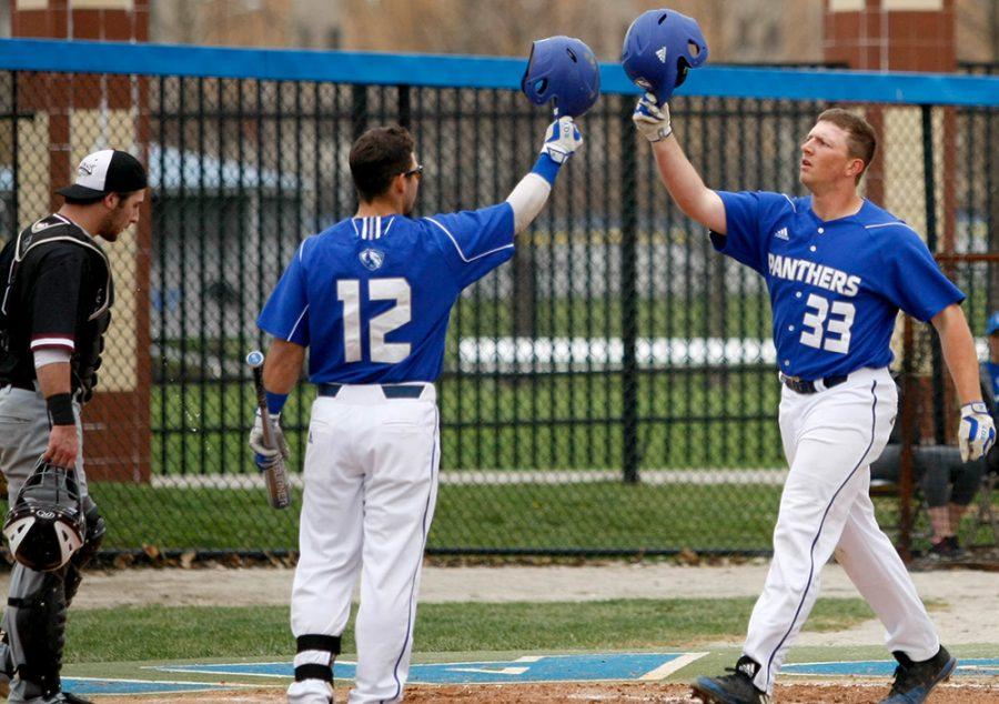 Junior Matt Albert is congratulated by teammate Frankie Perrone after his solo homerun in the bottom of 2nd inning Tuesday at Coaches Stadium. The homerun was Albert’s seventh of season.