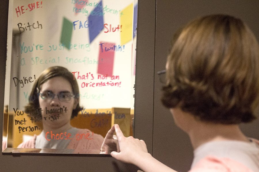 Lee Harper, a senior pshychology major,stares into a mirror with derogatory phrases sorrounding the LGBT community. “As an asexual person I get the you just haven’t met the right person yet. People just don’t understand,” says Harper.