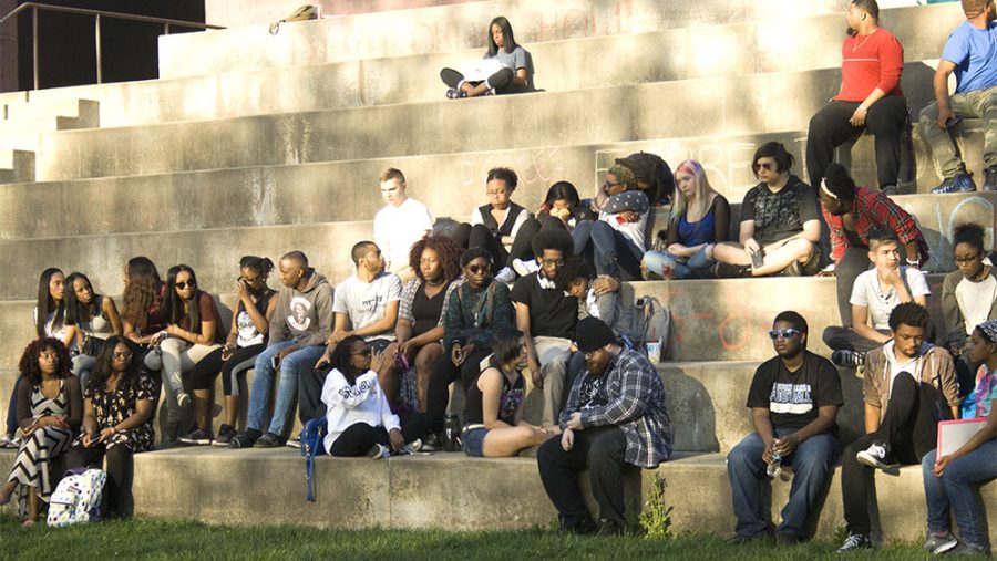 Students console one another after a moment of silence was held for Byron Edingburg, the Eastern Illinois student that was killed in a shooting over the weekend.