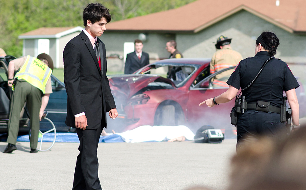 Justin Wilson, a Charleston High School senior performs a field sobriety test with an Eastern police officer during Wednesdays mock DUI exercise at the High School.