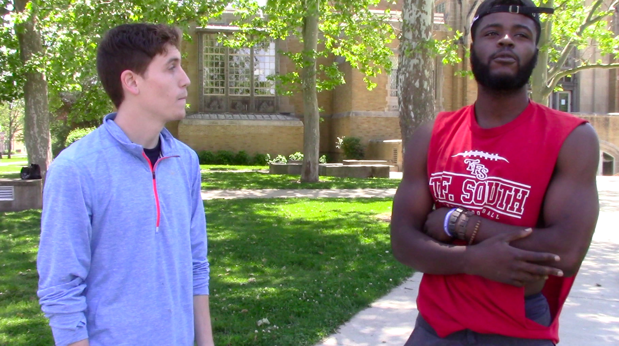 This is a screenshot from the video. It shows Managing Editor Brandon Winner interviewing student Vianney