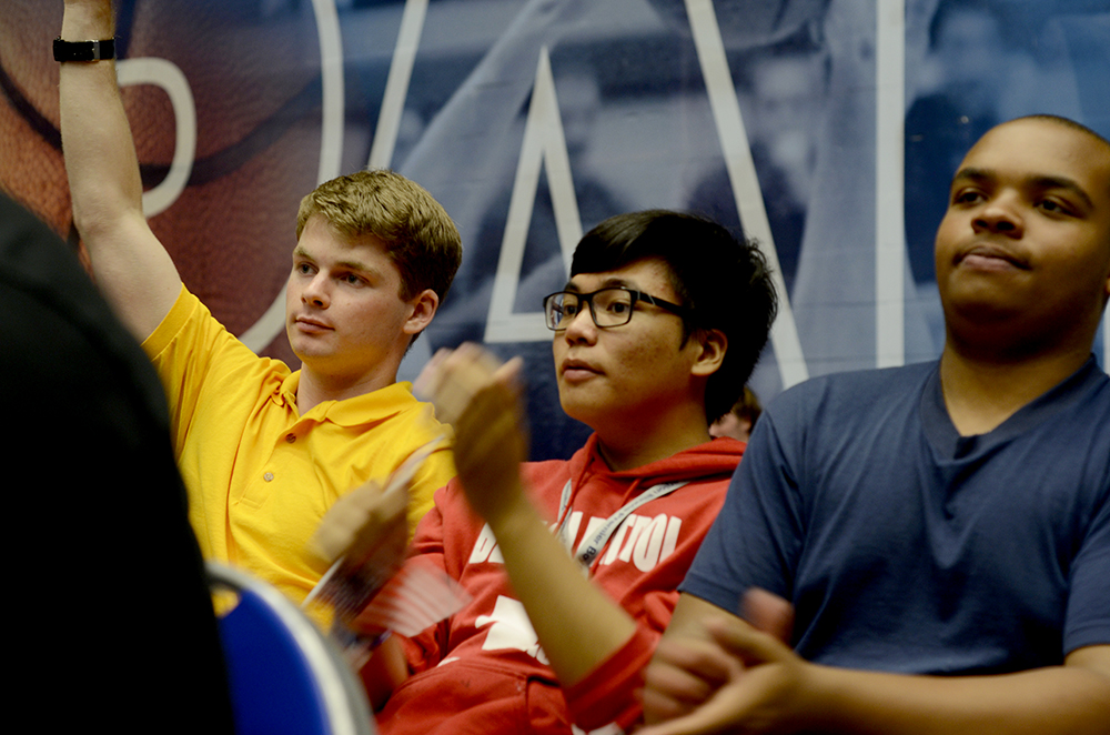 Casey Wells (left), a rising senior at Marian Central Catholic High School in Woodstock, raises his hand to ask Illinois Treasurer Michael Frerichs a question Thursday night during the Illinois Premier Boys State conference. Wells and his “commander” Joseph Douglas (right), a rising senior from Proviso East high school in Maywood, said one thing they took away from the week was the overall experience. “I’ll never forget this,” Douglas said as his teammates starred at him with admiration calling him their “master chief.”