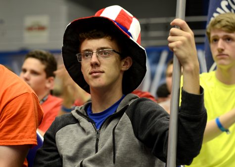 Jonathan Bozarth, a rising senior from Blue Ridge High School in Farmer City, wears a patritotic themed hat and holds his teams flag Thursday during a speech from state treasurer Michael Frerichs at the Illinois Premier Boys State conference. Bozarth said the one thing he took away from this week was, “being able to step out of your comfort zone.”