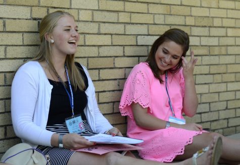 Keiley Meyer (left), a rising senior at Quincy Notre Dame High School in Quincy, starts singing the signature chant for the American Legion Auxilary Illinois Girls State while Hannah Brewster (right), a rising senior from Knoxville High School in Knoxville, smiles before starting to sing. Meyer and Brewster sat with their friends during recreation time Monday and talked about what they were running for and how the rest of the week might unfold.