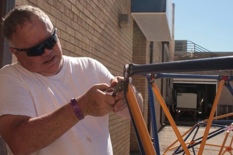 Bob Fayard, operations manager for the Cavaliers Drum and Bugle Corps, works on a piece of the set being used for the corps' 2017 production "Men are from Mars." Fayard has worked with the Cavaliers since 1987, stopped for a while, then came back when his son started playing with the drum and bugle corps. He said during the course of the summer and through traveling together, the Cavaliers grow closer as a group.  "I end up with 149 other sons," he said. 