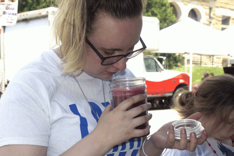 Emilia Kiskis, a kinesiology major, sniffs a candle at Musefest on Saturday.