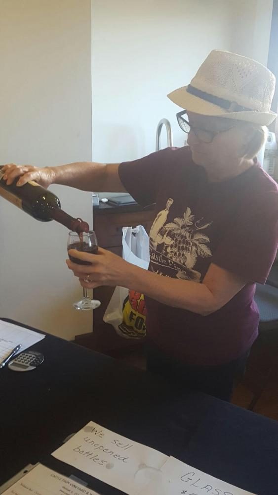 Linda Hendren, a volunteer, pours wine Saturday at the wine tasting event during the Mattoon Artworks Festival.
