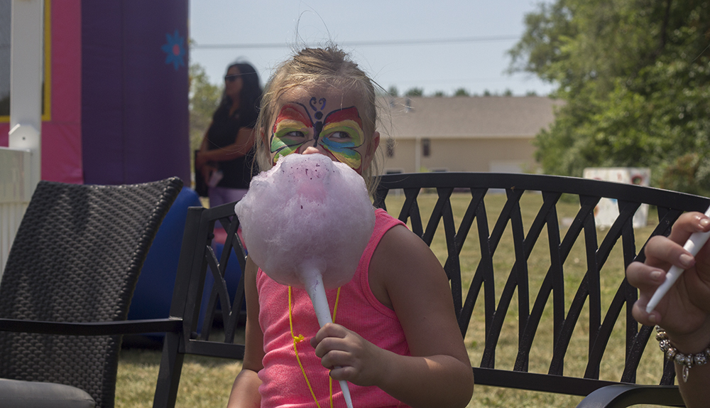 Ava Seaton, a five-year-old from Seaton, eats her cotton candy Sunday during a carnival hosted by the Arbor Rose Adult Day Care and Memory Care Home of Charleston. The carnival was an effort to raise money for the Alzheimers Association.