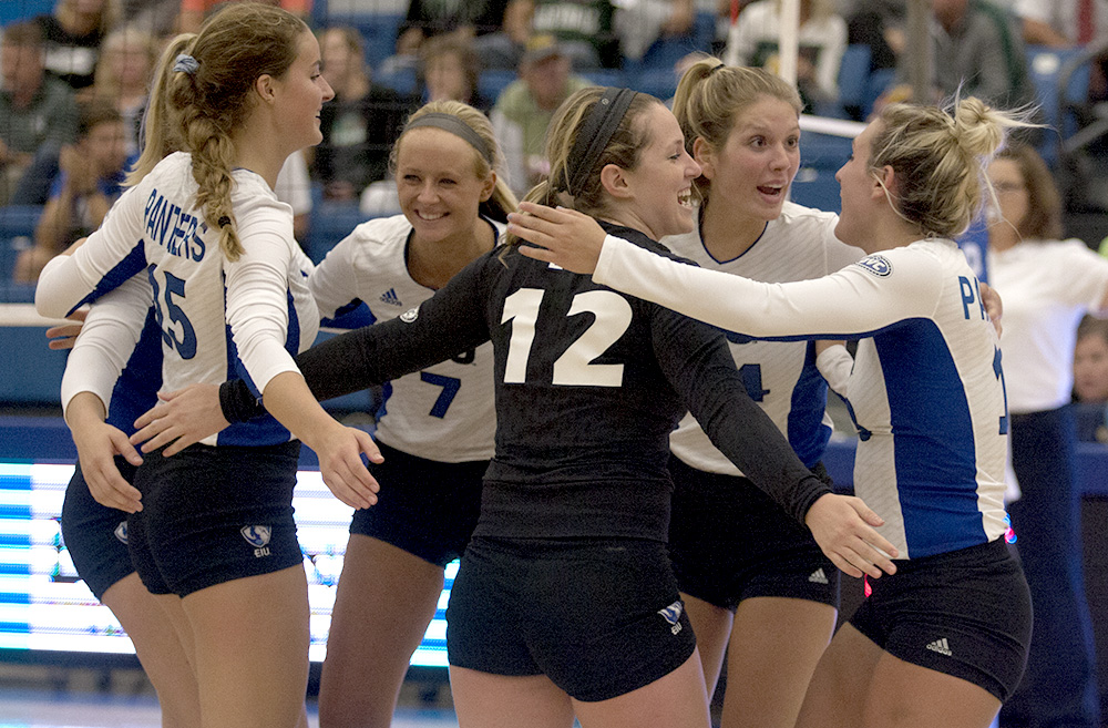 Freshman Laurel Bailey(15), junior Taylor Smith(7), redshirt sophomores Anne Hughes(12) and Gina Furlin(14), and senior Maria Brown(13) celebrate a point in their match against Green Bay Friday in Lantz Arena. The Panthers lost the match, but won both matches on Saturday against Memphis and Bradley.