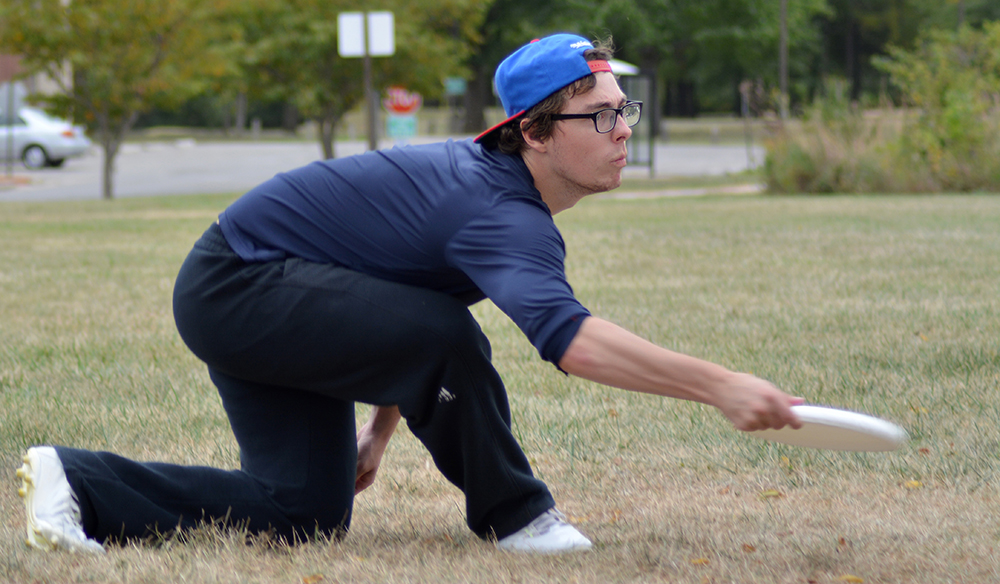 Junior James Porzio, a communications major performs a backhand throw while throwing with a teammate.