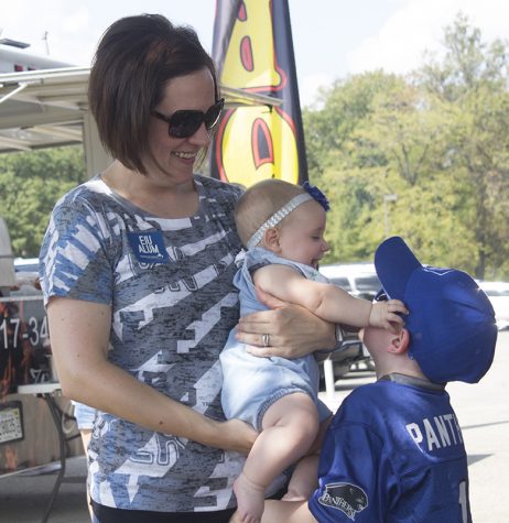 Claire Reifsteck from Tuscola spends some time with her children, Evan and Stella at a Tailgate on Saturday outside O’Brien Field. Reifsteck is an Eastern alumna and said she likes coming around campus with her family to have a good time.