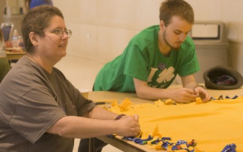 Jacob Barnard, an undeclared freshman and his mother Shelley Barnard make blankets for the Fleece Blanket Service Project Saturday in the University Ballroom at the Martin Luther King Jr. University Union. Shelley Barnard is from the Chicago area and said she came down to spend Family Weekend with her son.