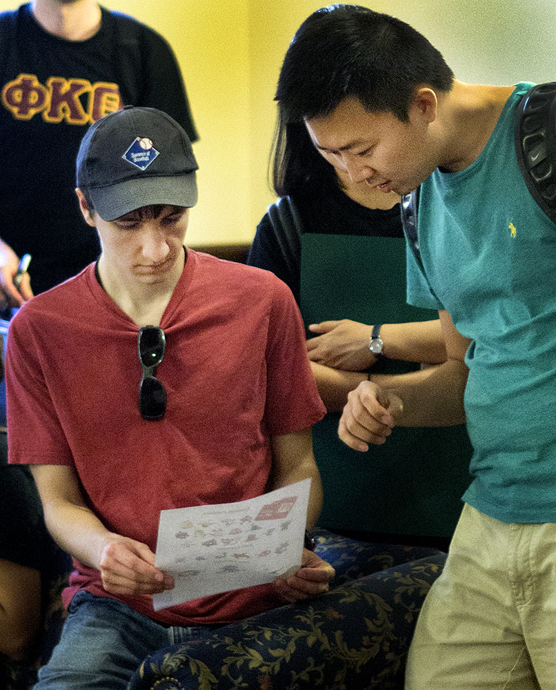Students check the Pokemon list and discuss finding tactics during the ROC Fest event EIU Go.