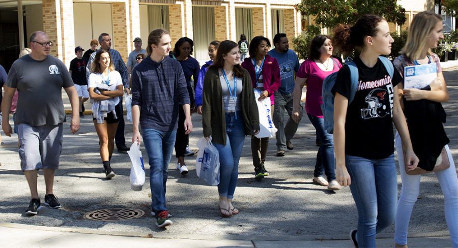 Prospective students and their families walk outside the Martin Luther King Jr. University Union at the open house Monday afternoon. Prospective student Katherine Hahn-Boisvert said she is interested in Eastern because of the journalism and biological science departments.