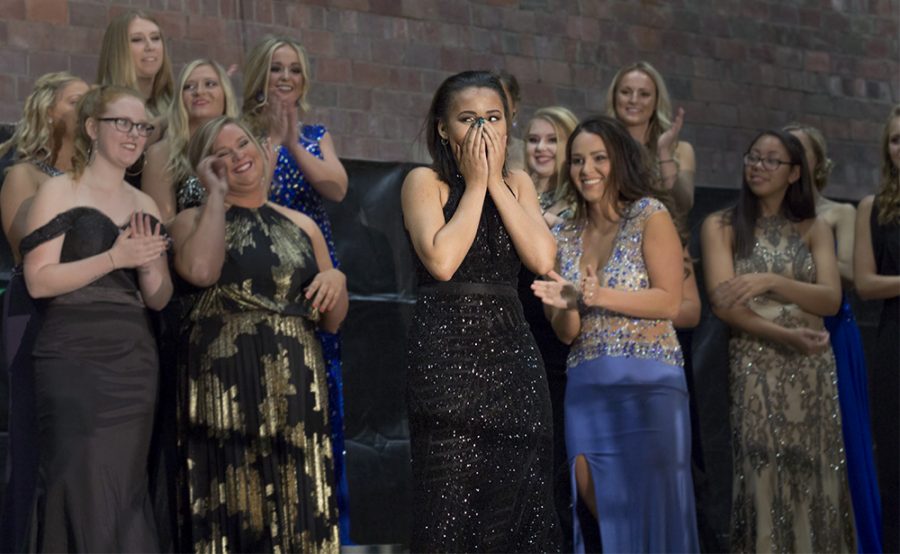 Allison Oates, representative of Lincoln Hall and the NACWC, approaches center stage to receive her crown at the coronation event Monday evening.