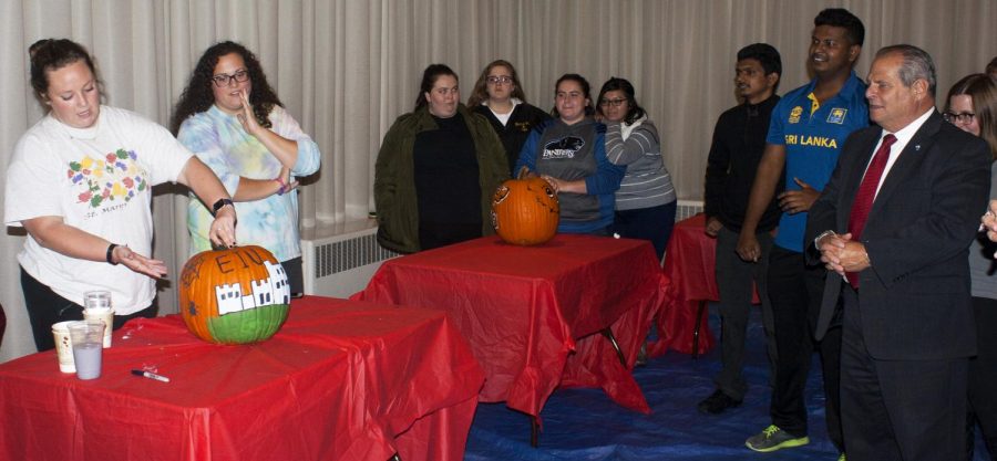 Students+from+Sigma+Sigma+Sigma+%28left%29+showcase+their+pumpkin+to+Eastern+President+David+Glassman+%28right%29+and+other+students+during+%E2%80%9CPumpkins+with+the+Prez%E2%80%9D+at+the+University+Ballroom+located+at+the+Martin+Luther+King+Jr.+University+Union+Monday+night.