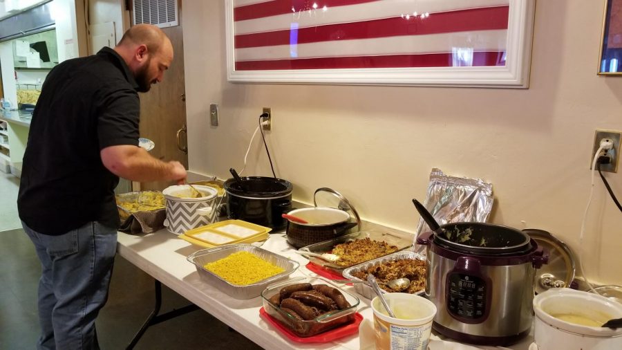 Scott Kroner, a senior business major, fills a plate with food during the Thanksgiving potluck last Thursday at the Charleston Elks Lodge 623. “The meaning of Thanksgiving is to eat until you cannot eat anymore, then take a nap. If you’re not doing that, you’re doing it wrong,” Kroner said.