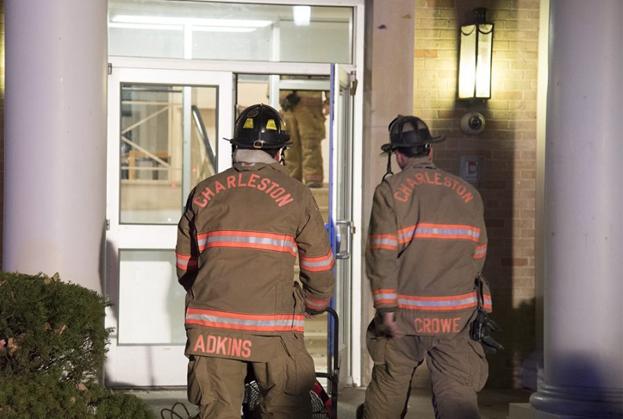 Two firefighters enter Douglas Hall Wednesday night after a fire broke out in the buildings attic.