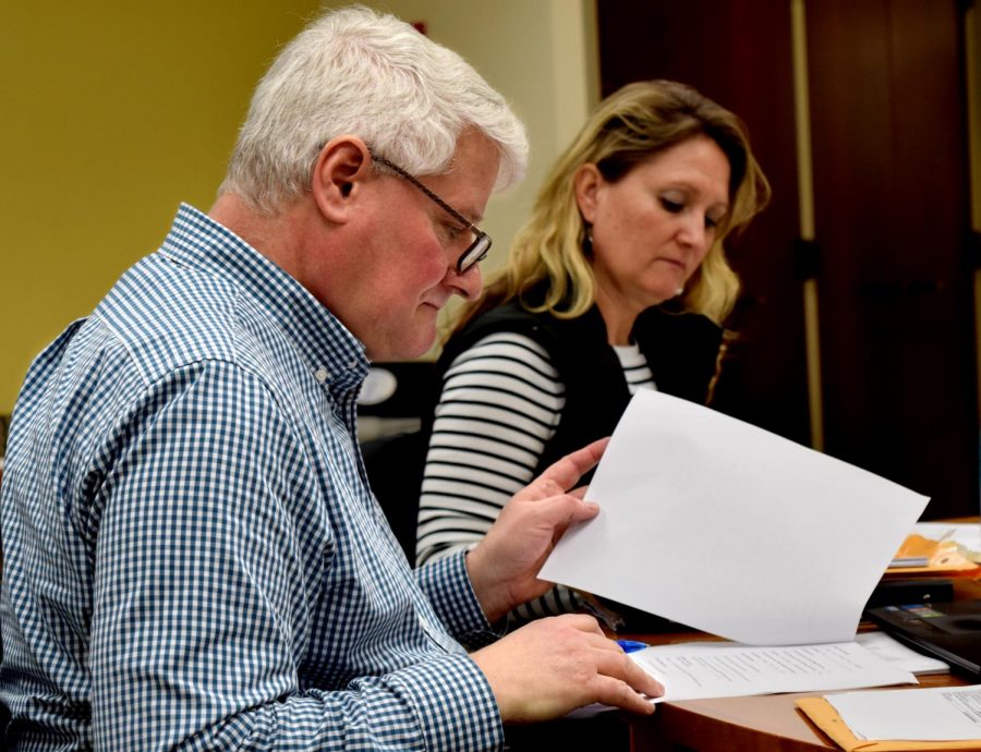 CAA vice chair Richard Wilkinson, a family and consumer sciences professor, sits with CAA chair Stacey Ruholl, a kinesiology and sports studies professor. They are looking through family and consumer sciences course proposals, all of which were passed unanimously at the Council on Academic Affairs’ meeting Thursday.