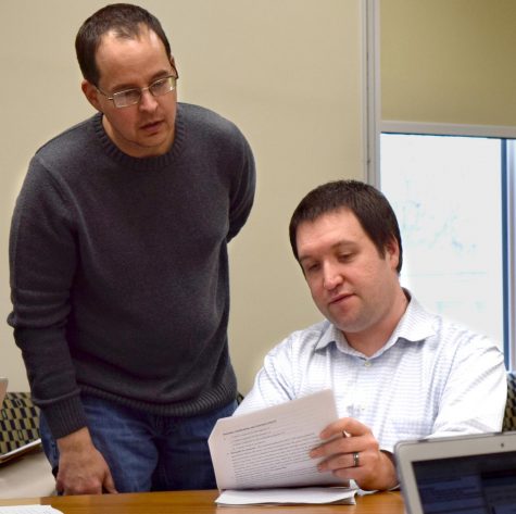 Mathematics and computer sciences professors Grant Lakeland and Peter Wiles, double check the specifics on one of their course revision proposals at the Council on Academic Affairs meeting Thursday afternoon in Booth Library. 