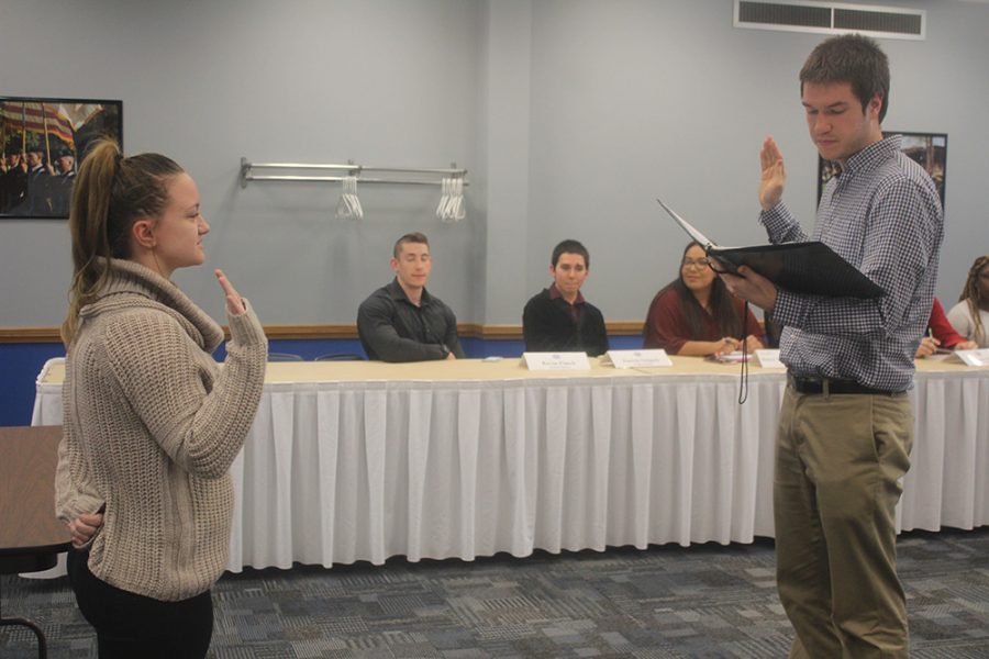 Maddie Tate, a freshman early childhood education major is appointed into Student Senate by Luke Young, the Student Body President at a Student Senate Meeting in the Arcola Room on Wednesday evening.