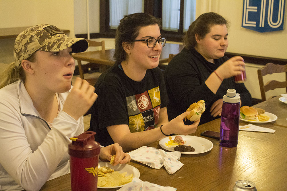 Students, Kelsey Knopp, a sophomore special education major, Caroline Egan, a junior english major and Kayley LaGrou, a junior middle level education major dine on food during “The Hunger Banquet” inside of Permberton Hall on Wednesday evening.